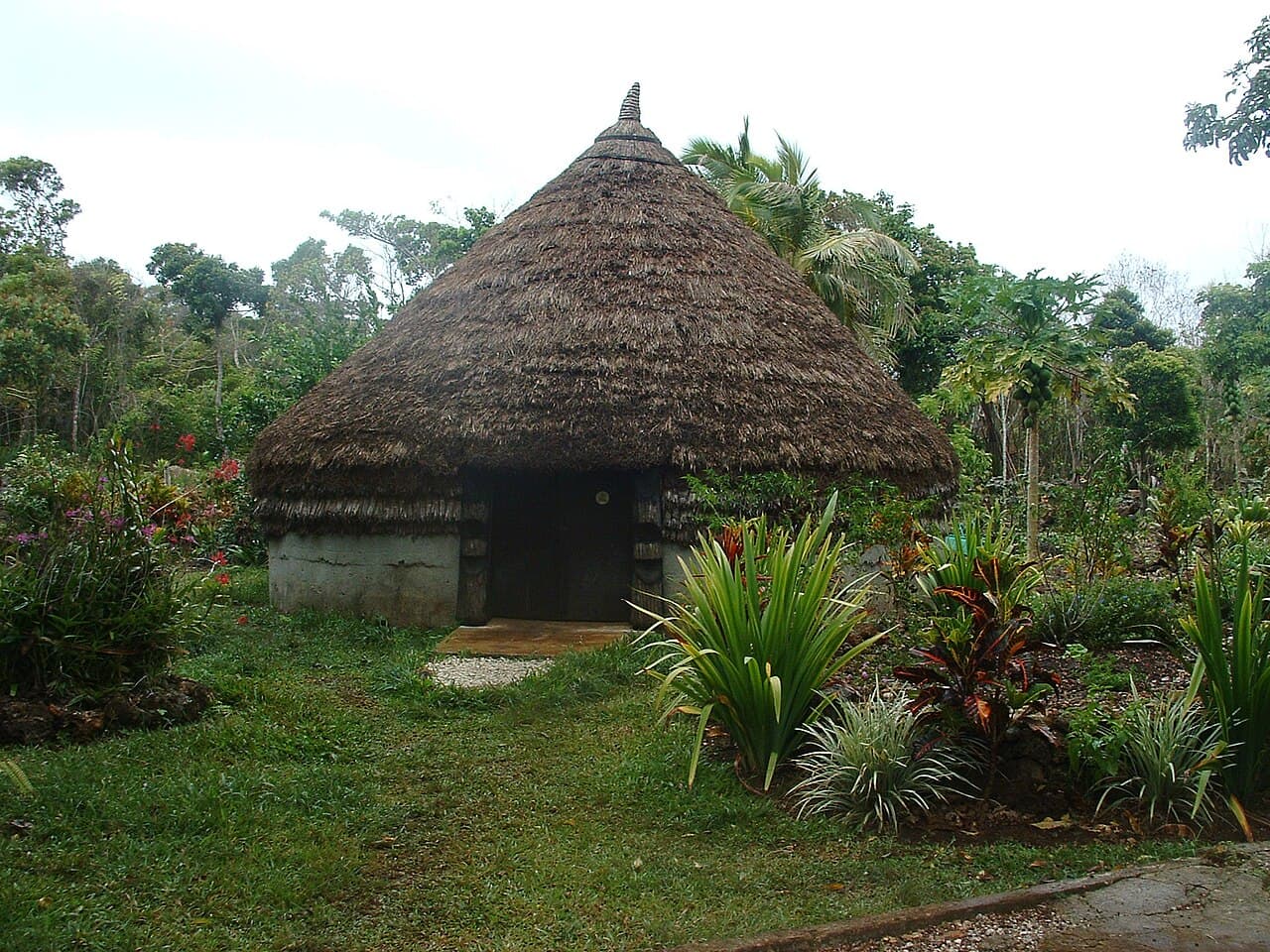 A traditional Kanak case on Lifou, New Caledonia, with a conical thatched roof and a carved roof spear at its apex
