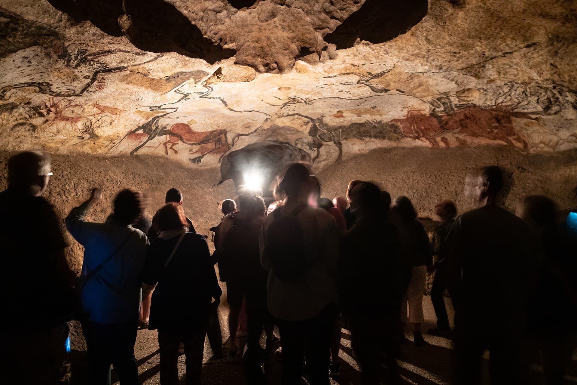 Visitors looking up at the painted ceiling in the Lascaux II facsimile