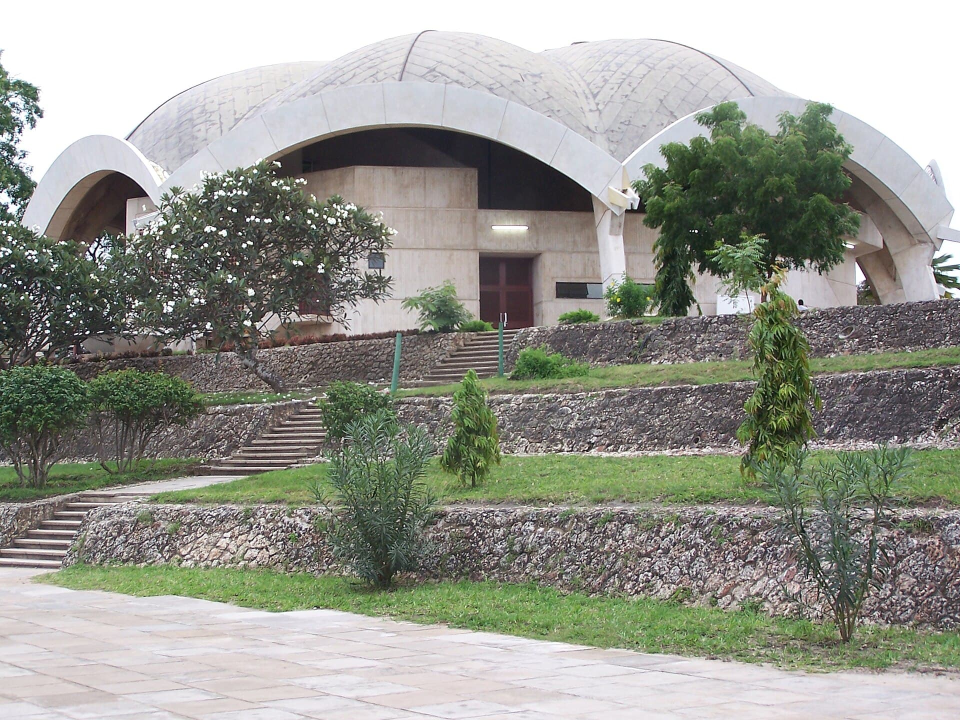 Nkrumah Hall, the university's assembly building, its concrete shell vaults rising above terraced coral stone walls