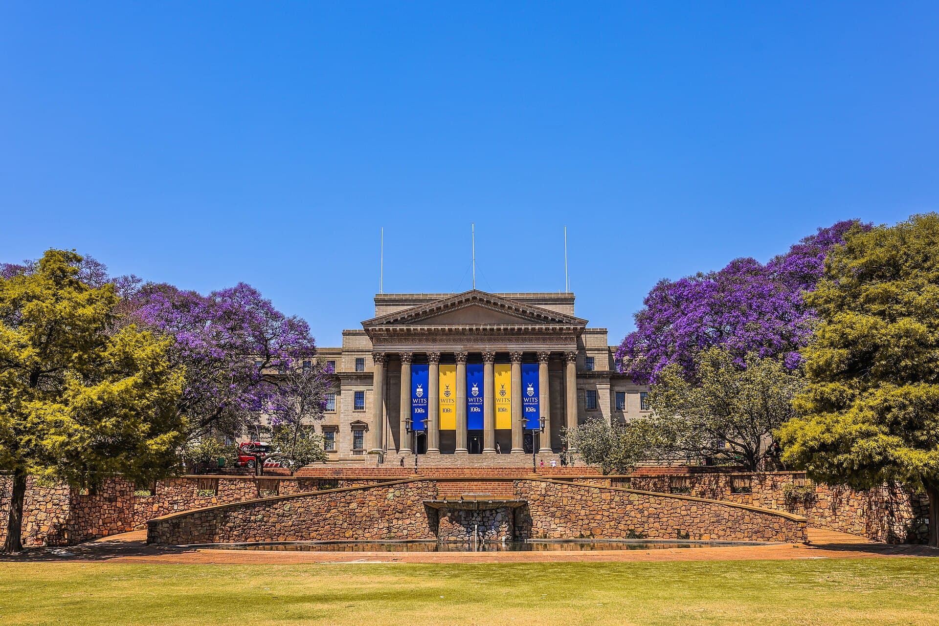 The Great Hall of the University of the Witwatersrand with jacarandas in bloom